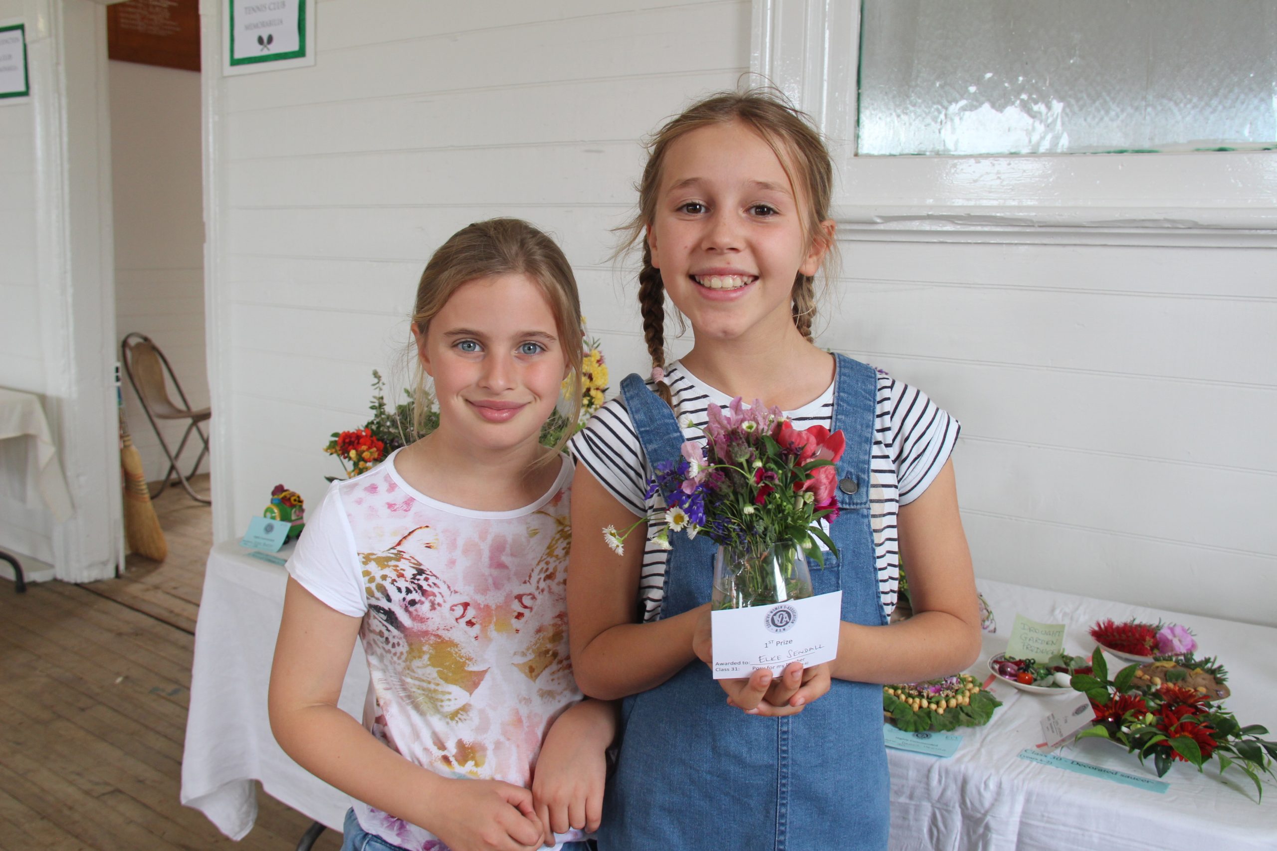 Emmie Moore and winner of the ‘Posy for my teacher’ category Elke Sendall. Elke Sendall’s grandmother Margaret Sendall cut the riboon at the hall’s reopening.