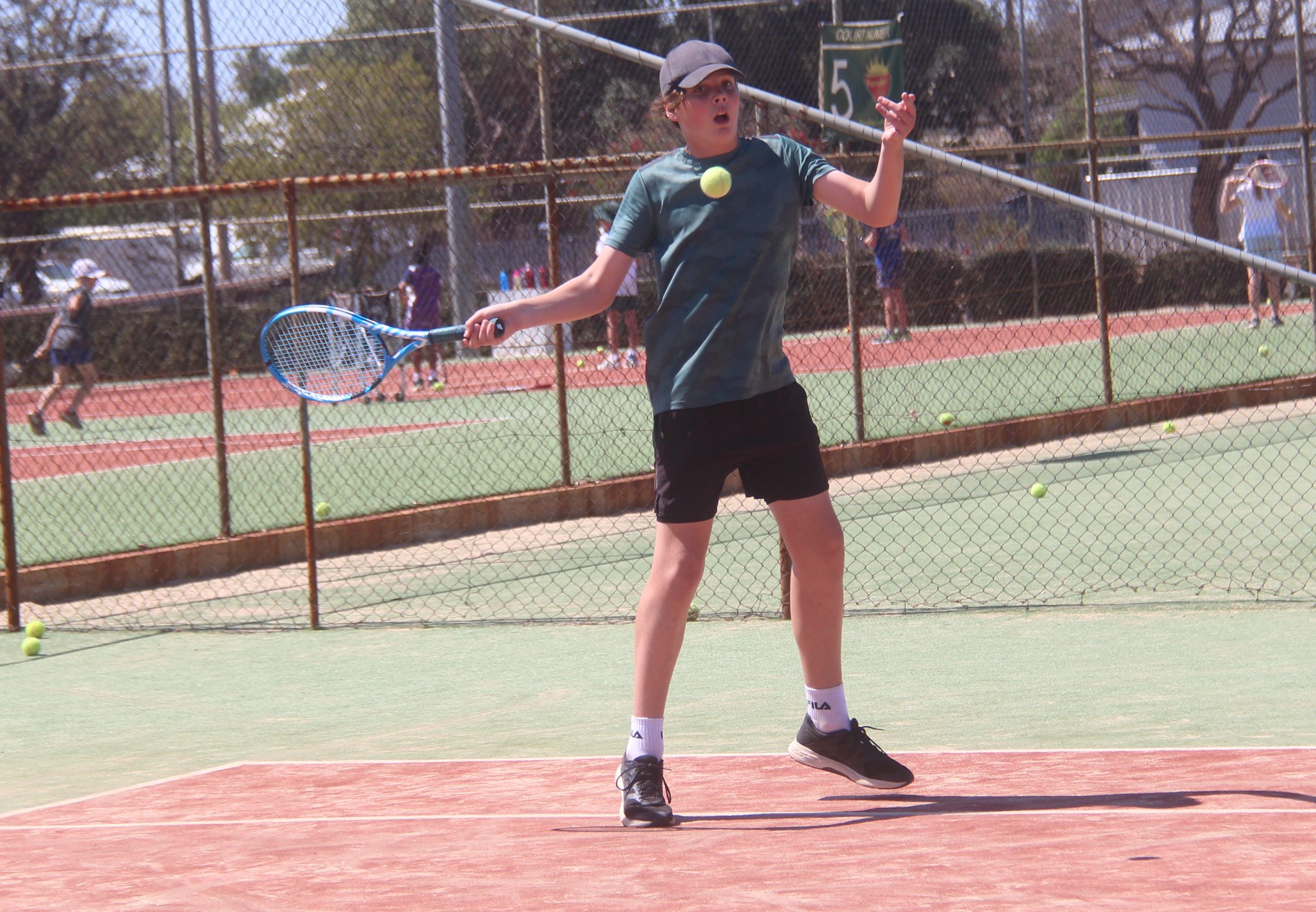 Callum Wales blasts a forehand over the net.