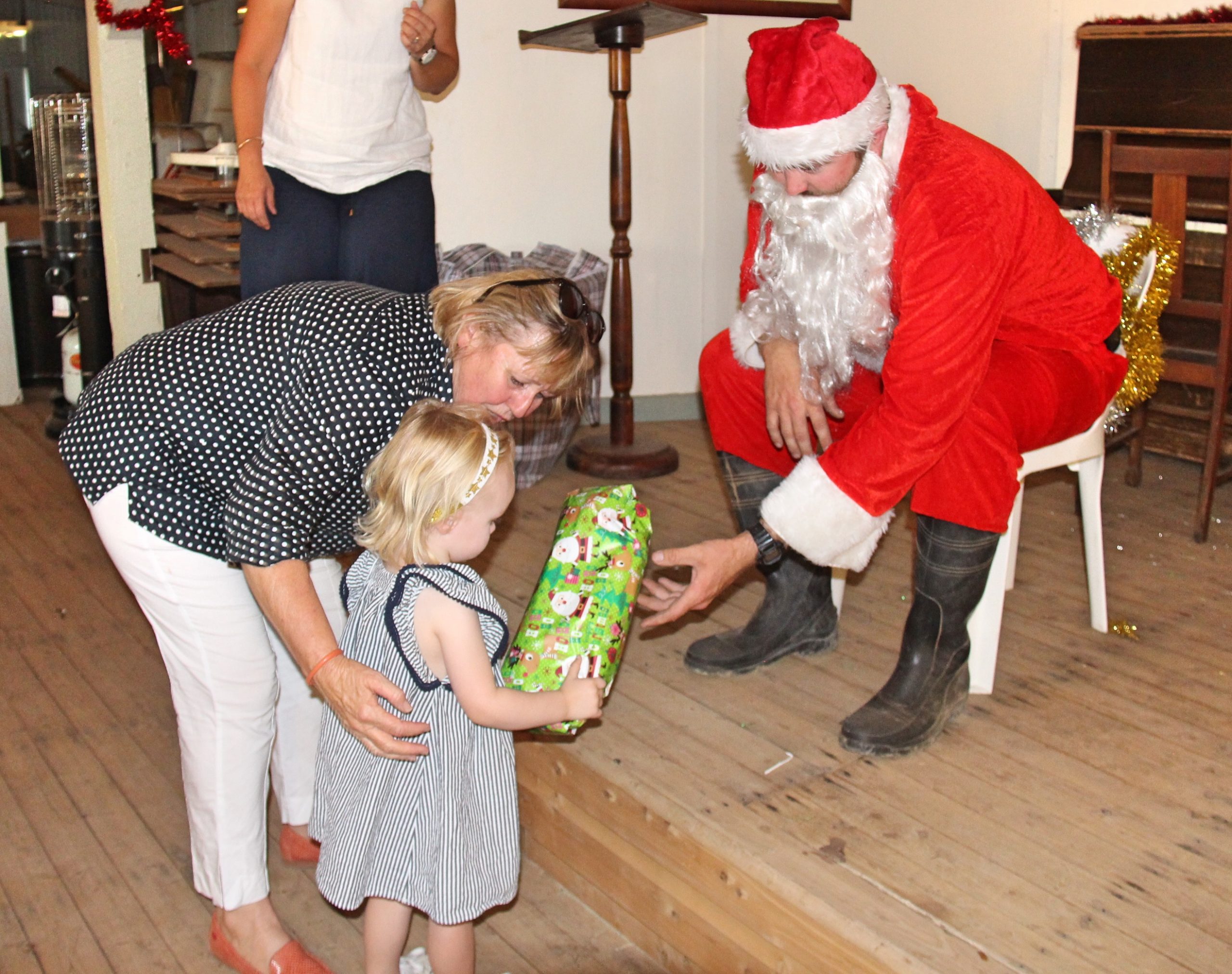 Sally Boyle with her granddaughter Evie Boyle receiving a gift from Santa.