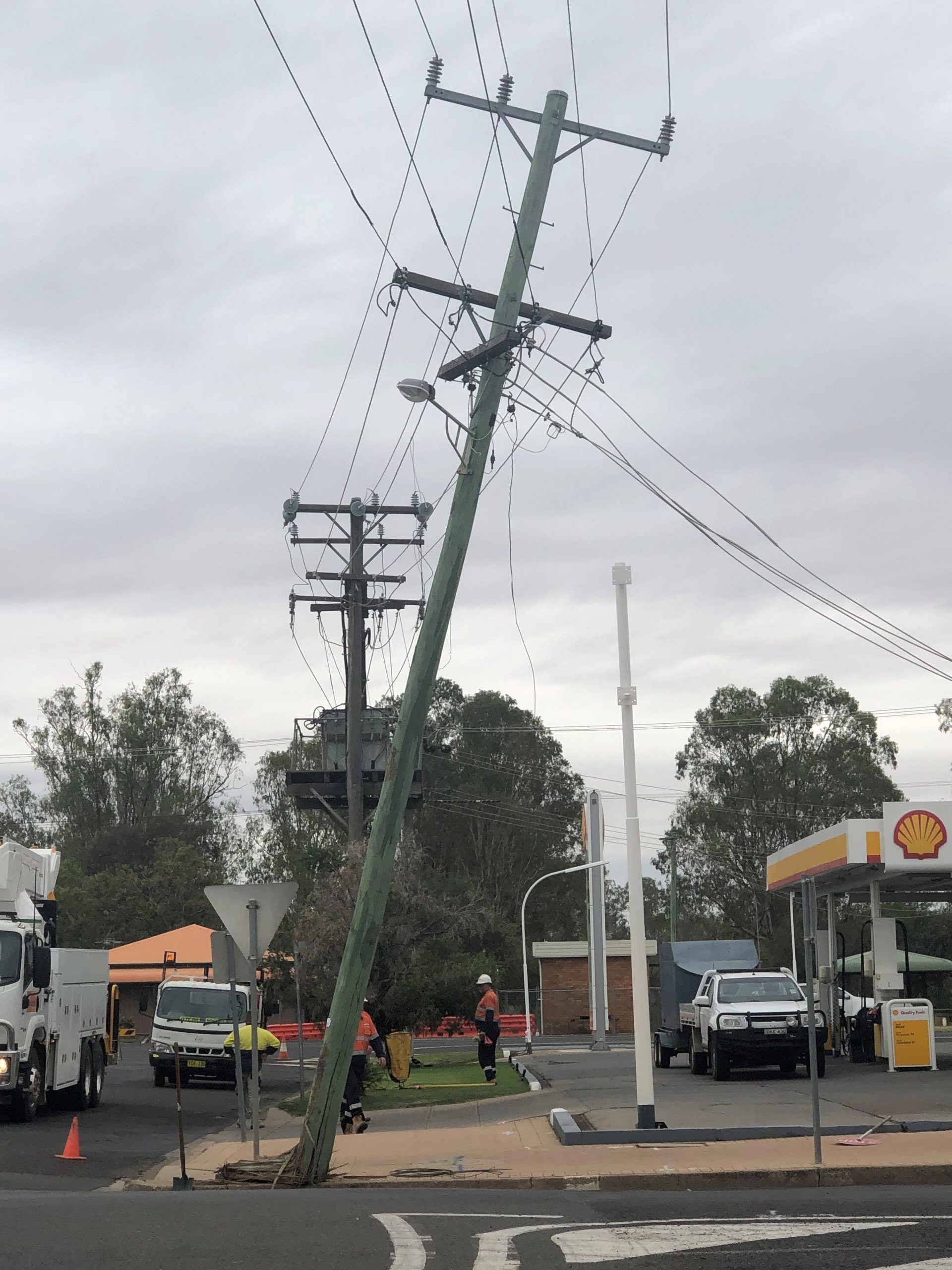 Truck breaks power pole on main street