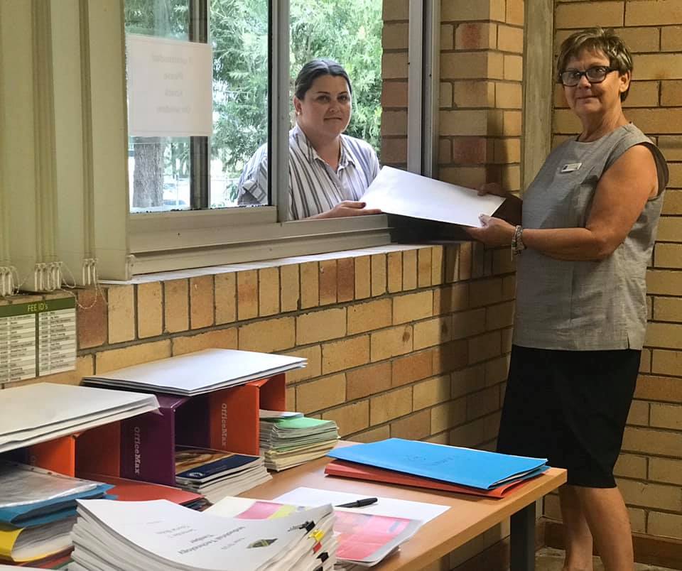 WWHS administrative support team members Penny Dubbelde and Janelle Lilliebridge getting hard copy work ready for collection for students working from home.