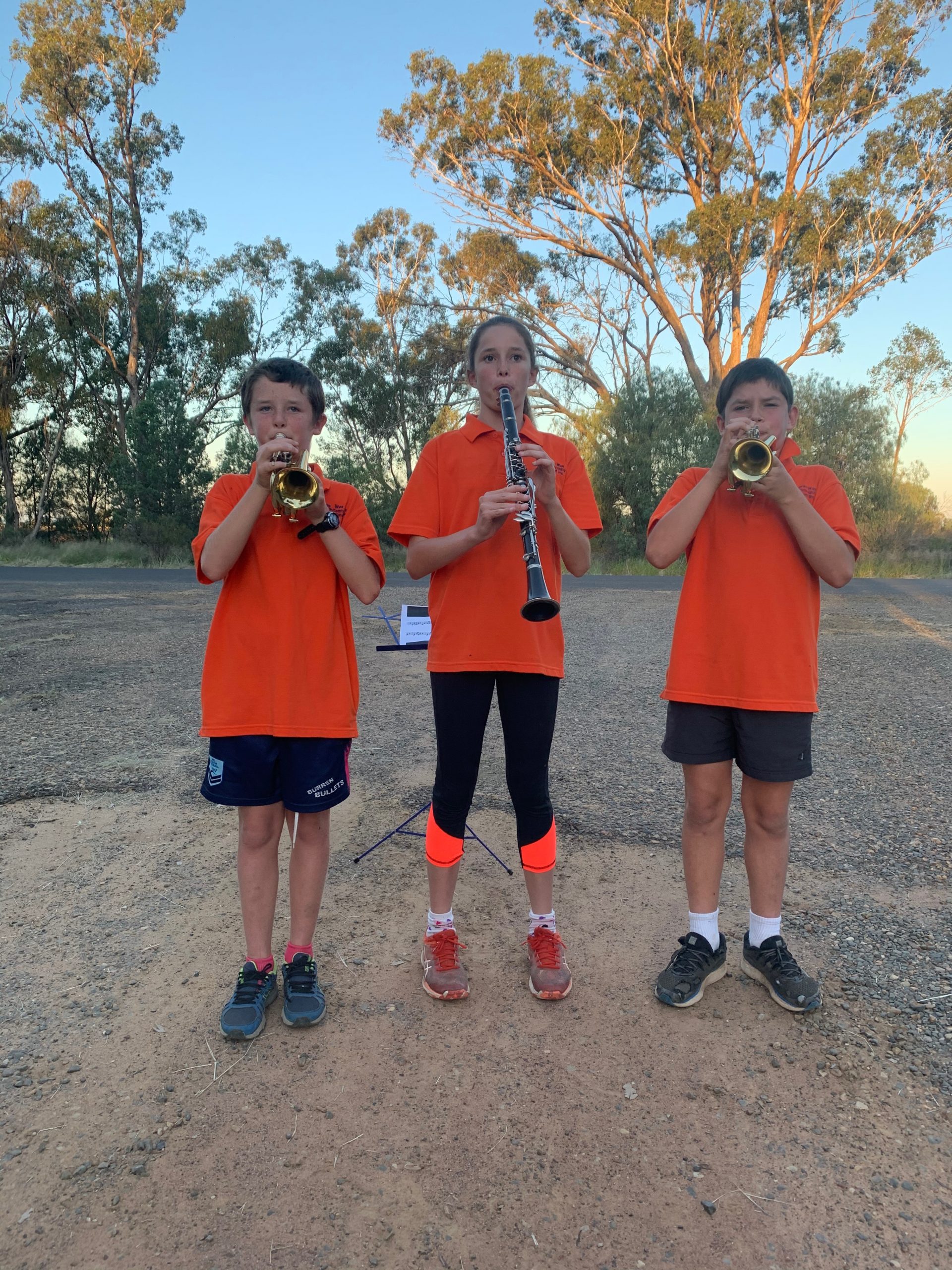 Siblings Charlie, Tess and Ted Haire who are members of the Wee Waa Community Band joined other band members in sounding the Last Post from their driveway at 6am on Anzac Day.