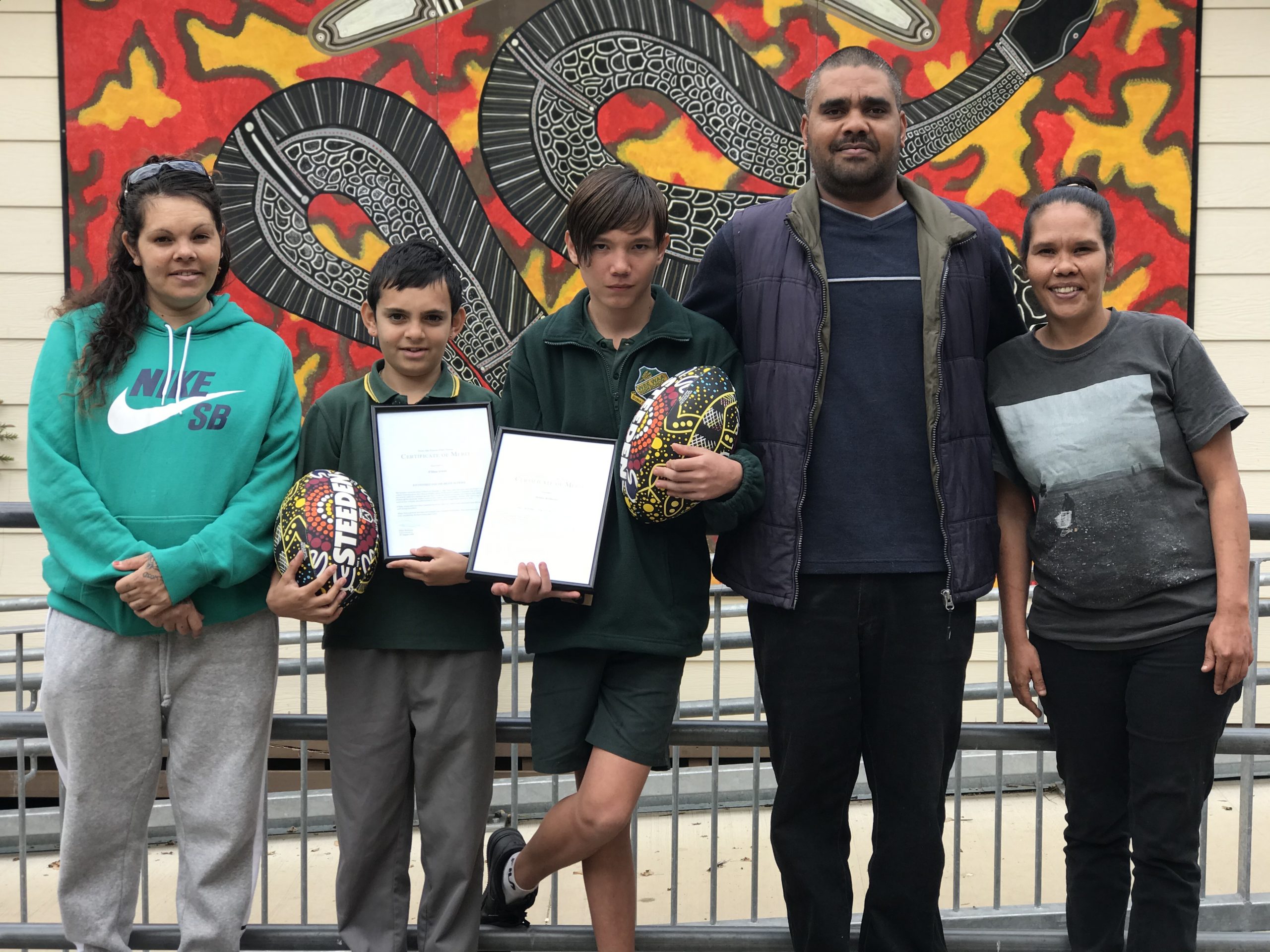 Rashard and O’Shea Green’s mum Camille Green, O’Shea Green holding his Certificate of Merit in recognition of his brave actions, James Williams holding his Certificate of Merit in recognition of his brave actions, James’ uncle Alex Barden, James’ mother Melinda Williams.
