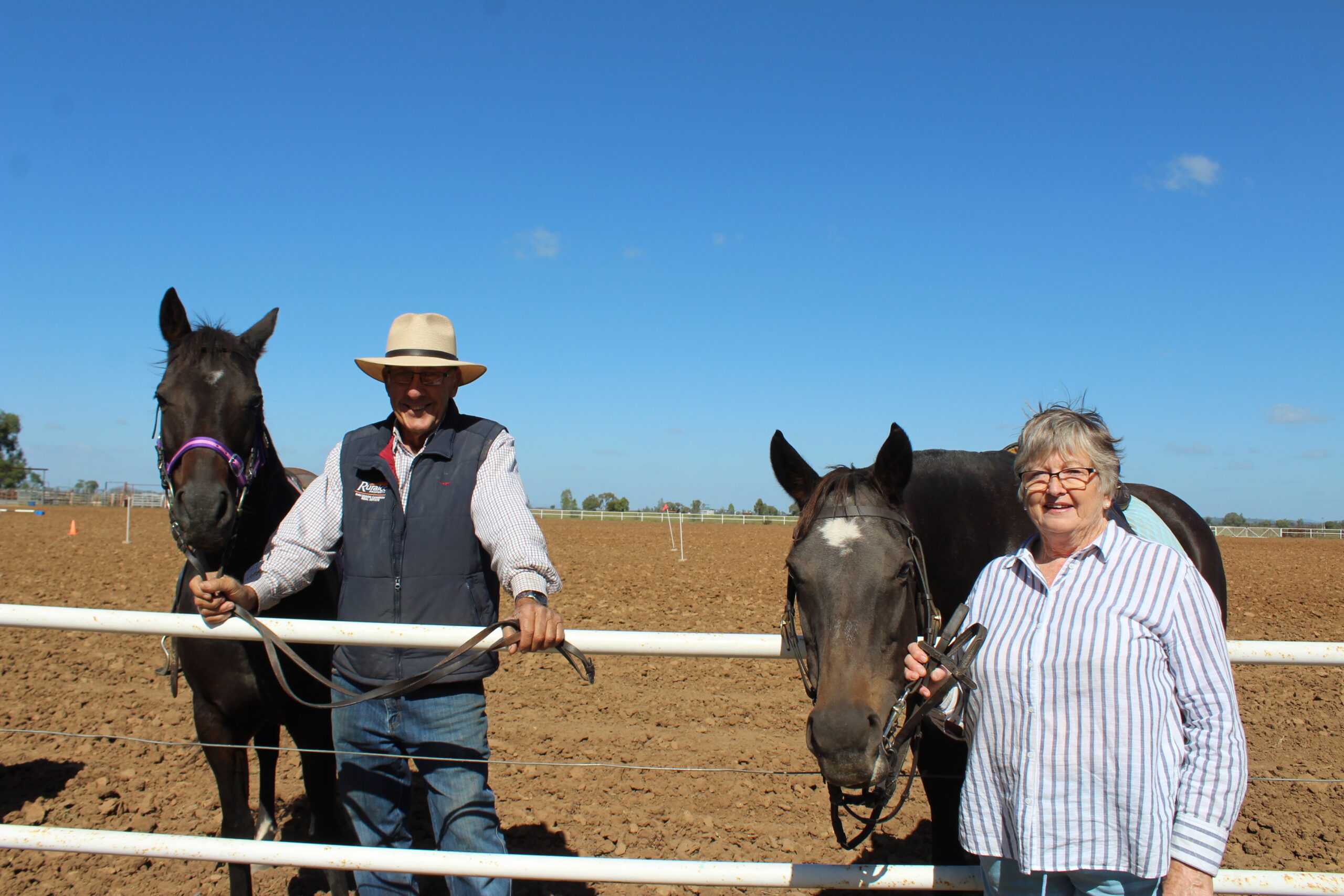 Barry and Kerry Thomson holding their grand-daughters’ horses during morning tea.