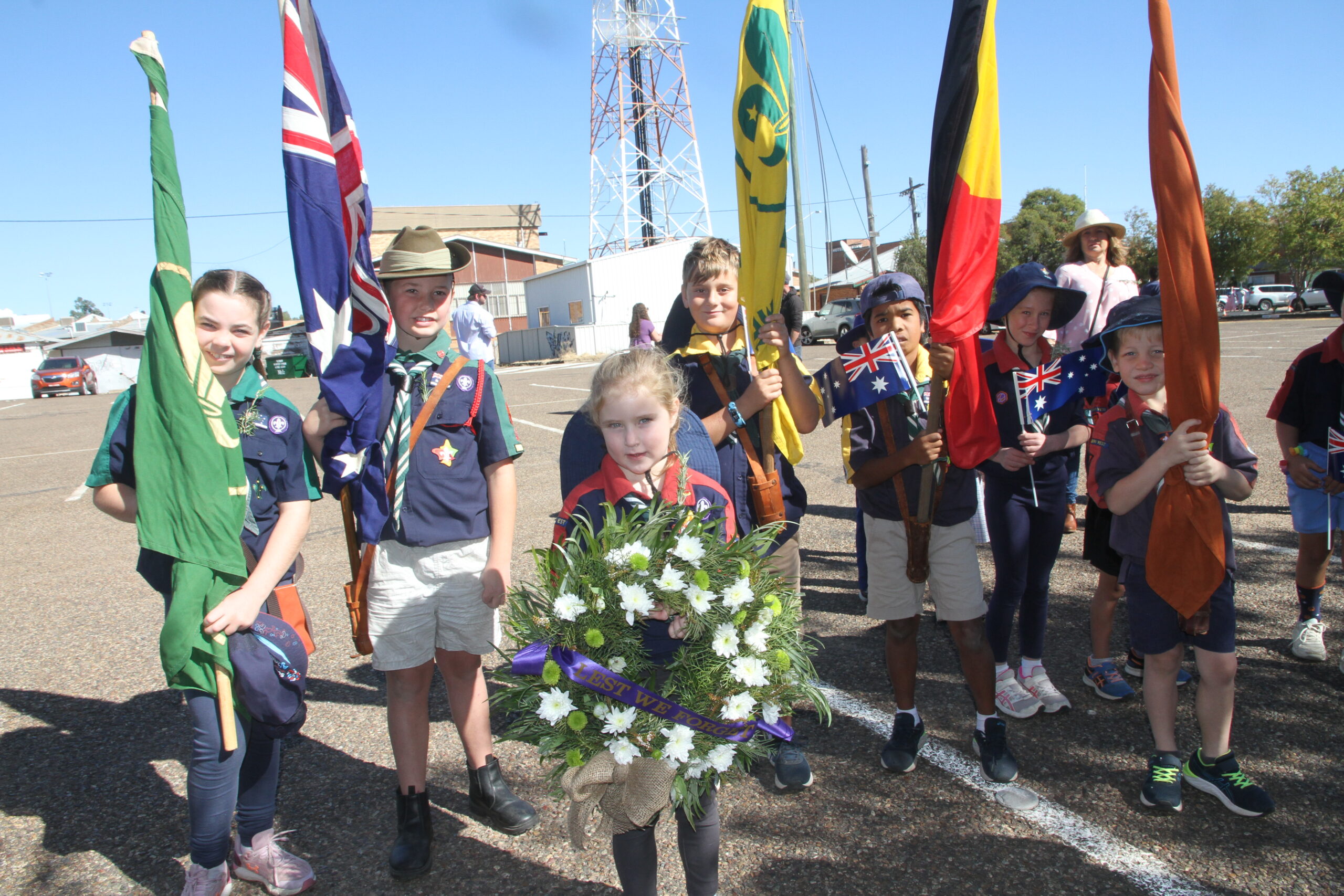 The Scouts - back, Millie Crossing, Ethan Harris, Jordan Dunn, Michael Clayton-Harris, Lillian Davies, Harry Crossing, Harry Dunne (obscured), Lachlan Dunn, and front with wreath, Rosie Davies,