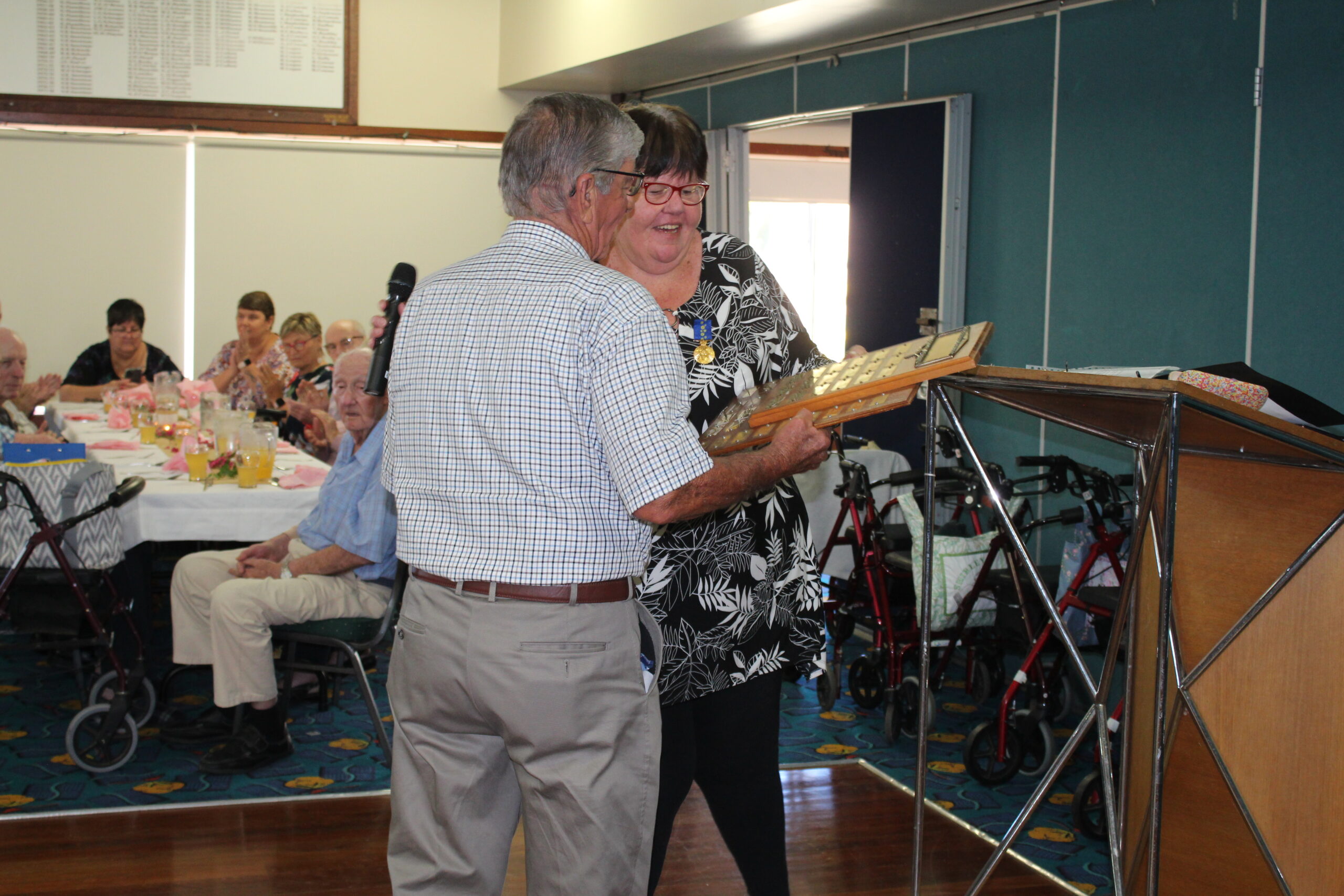 Kevin Horne accepting his award from Julie Dowleans (OAM).