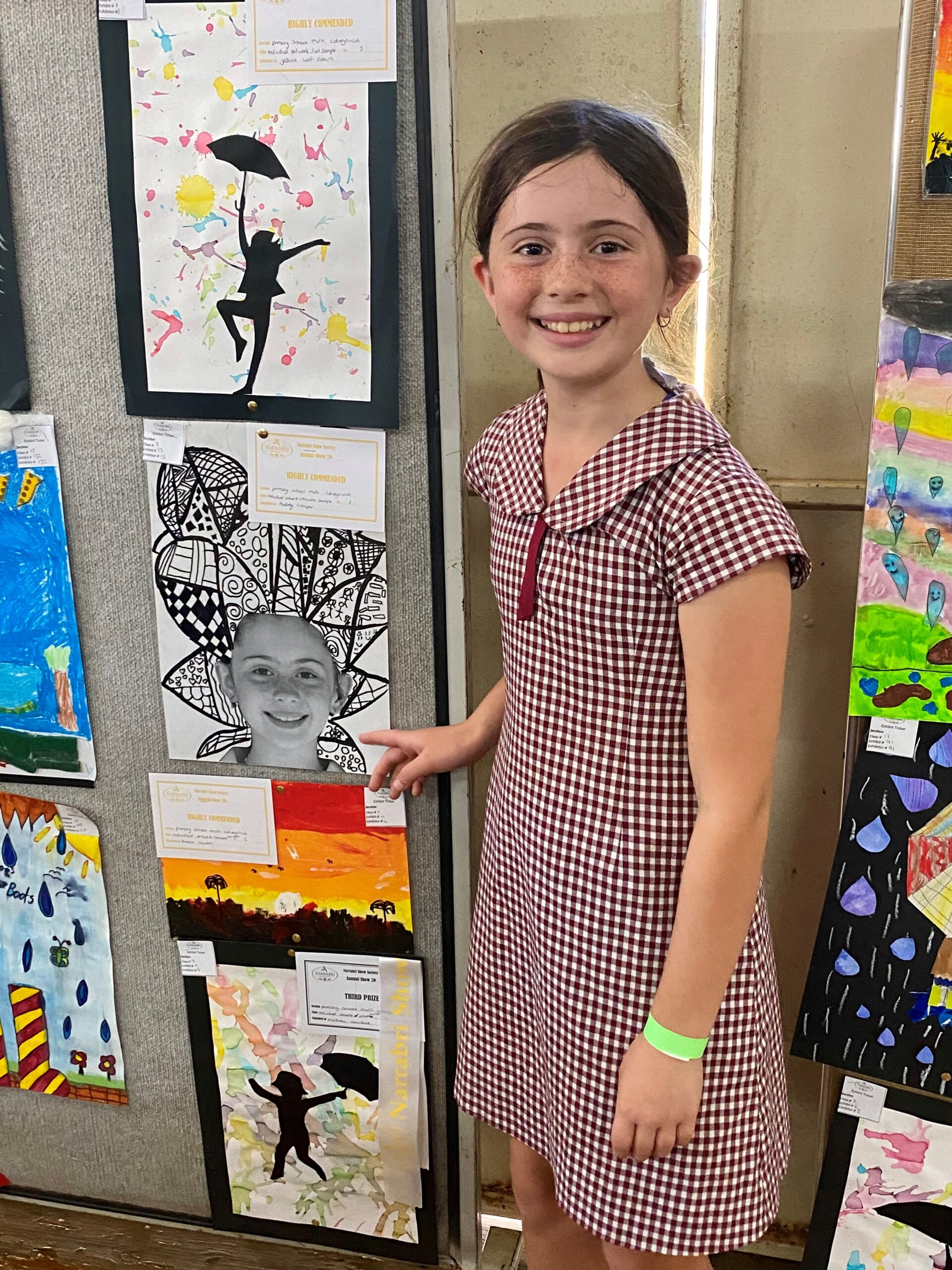 Bellata Public School student Audrey Cooper points to her artwork which was highly commended.