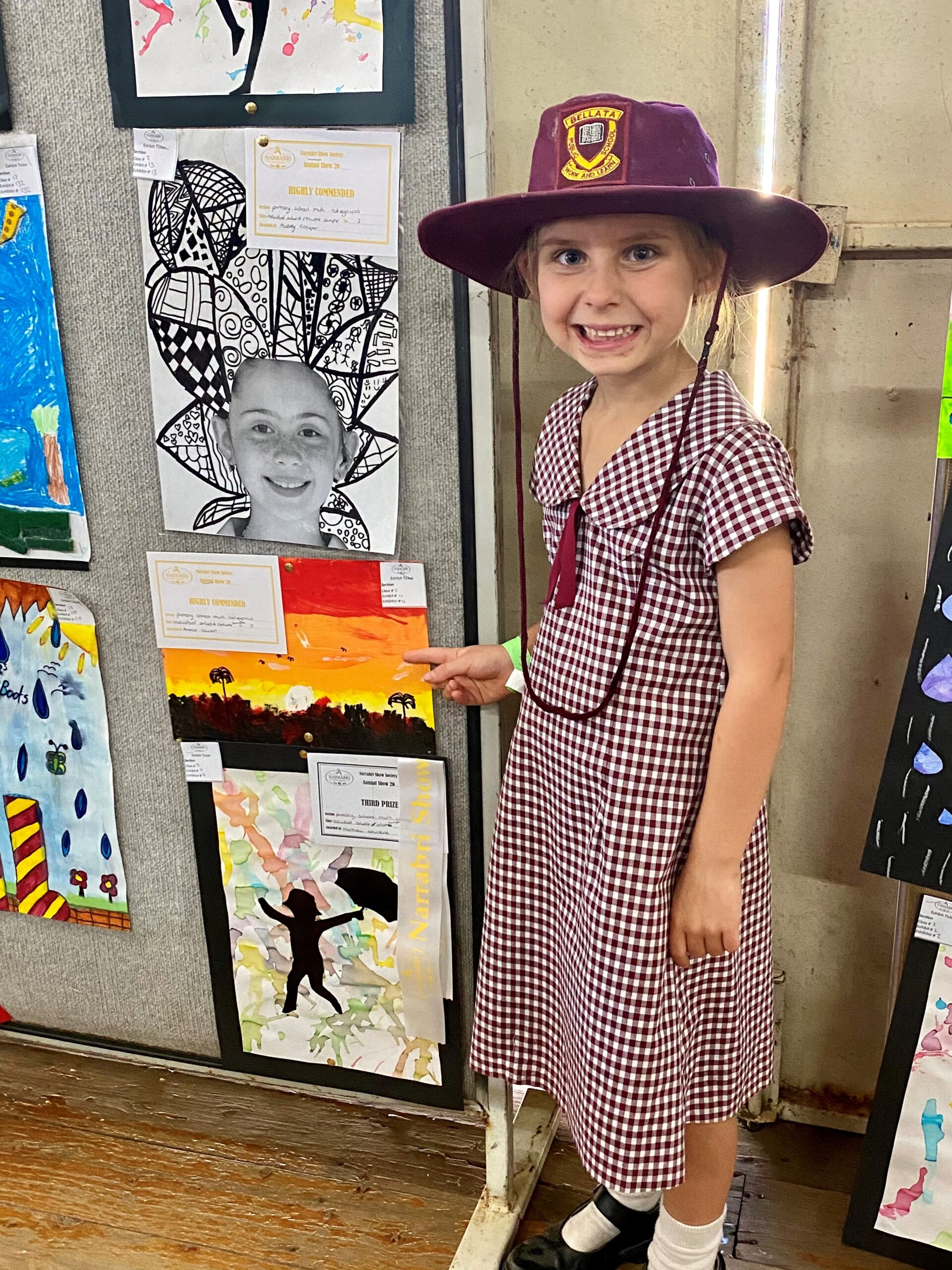 Bellata Public School student Amelia Lowien points to her artwork which was highly commended.