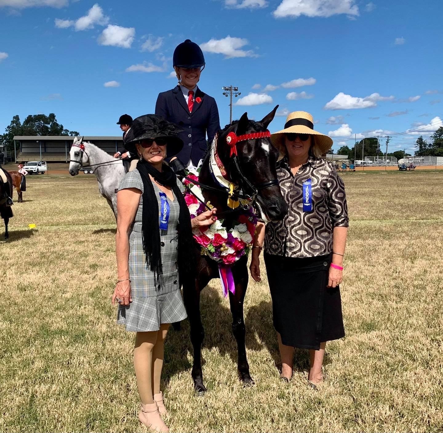 Supreme champion hack was awarded to Amelia Kearney riding Lyndhurst Miss Hong Kong. She is with judges Catherine Mills and Sue Foreman.