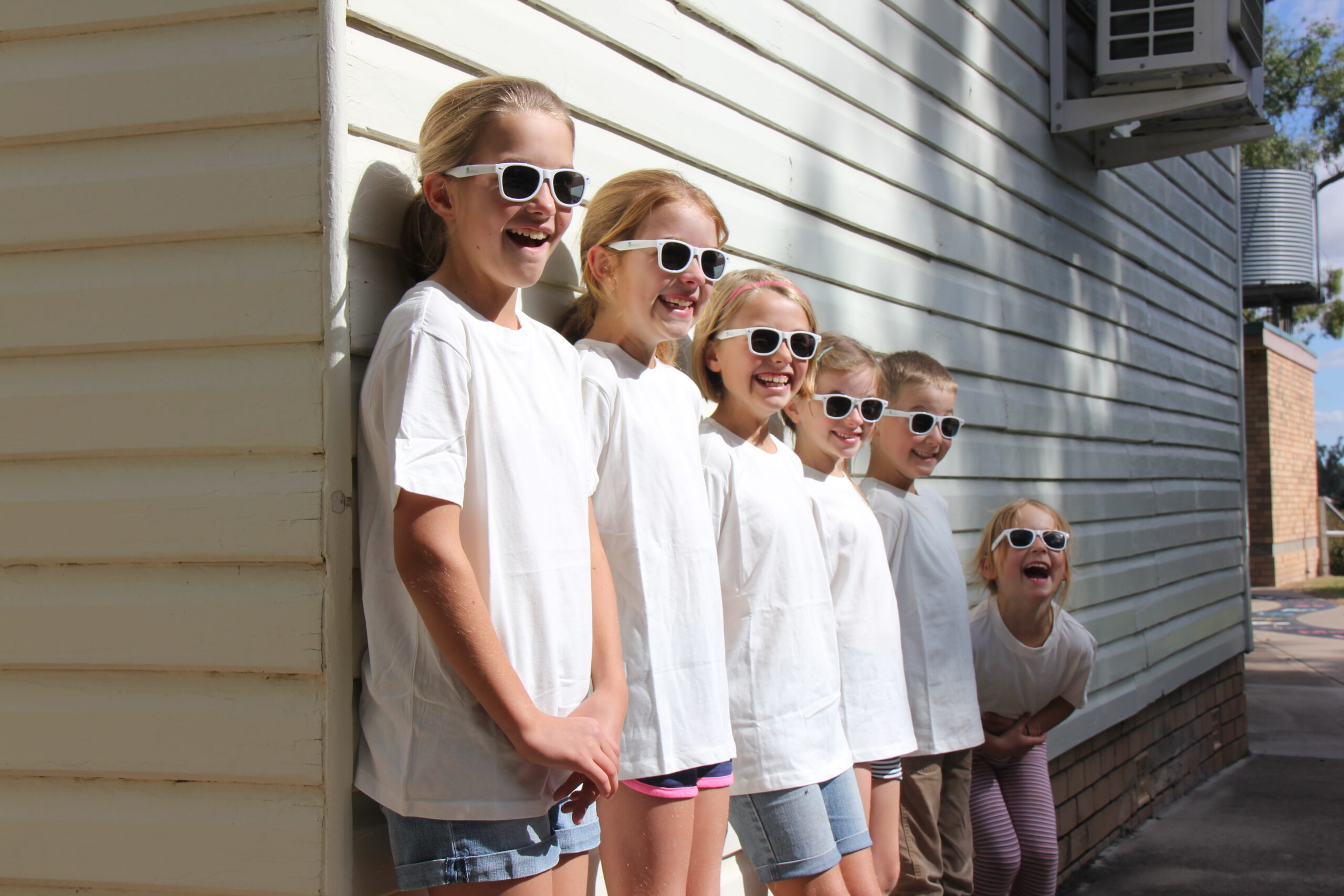 Before the colour run: Fairfax Public School students Eileen Murphy, Chelsea Nobilo, Molly Murphy, Grace Nobilo, Jackson Smith and Ella Smith in their white sunglasses and shirts, donated by NDCAS.