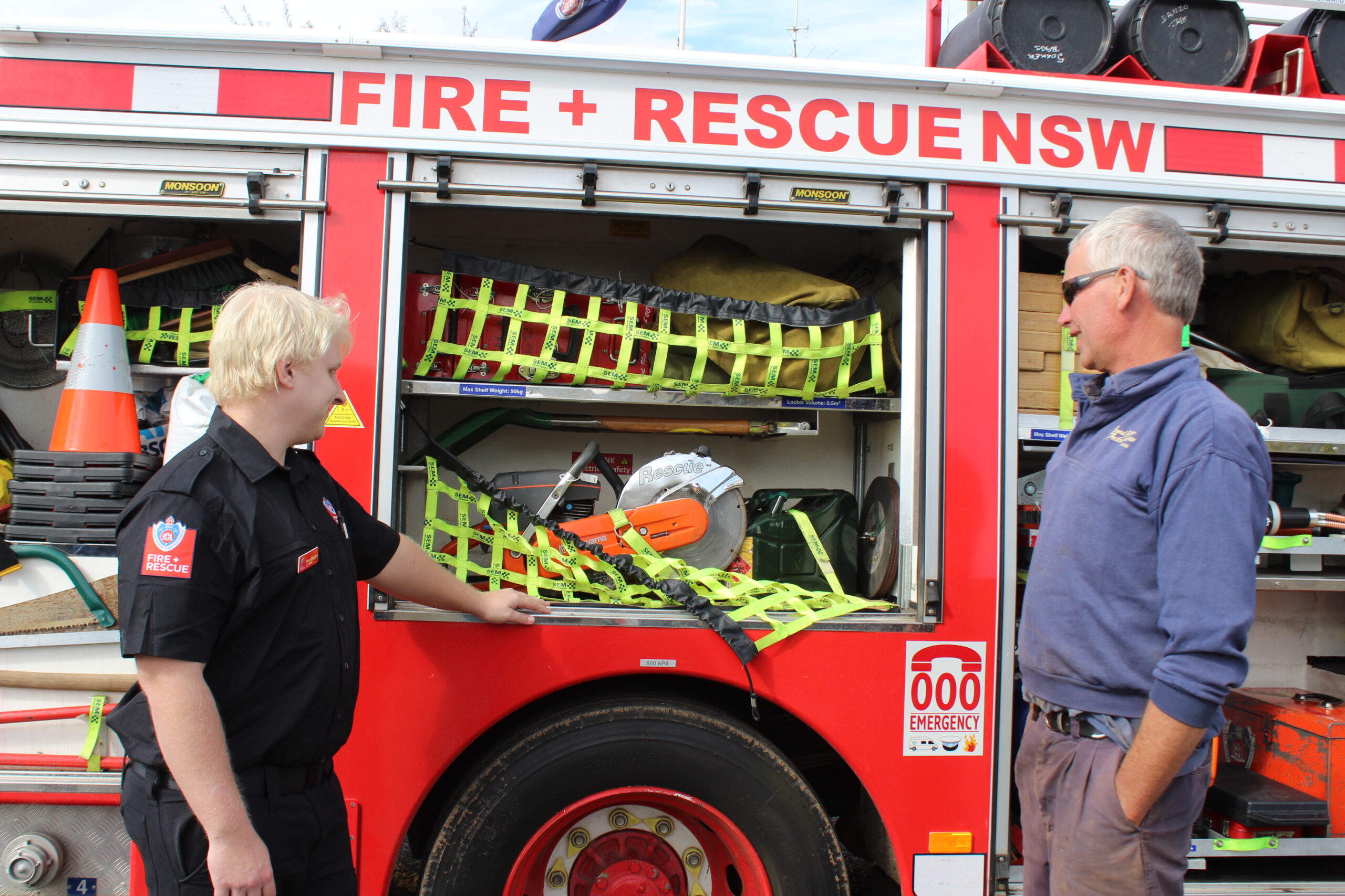 Dean Tomlinson looking at some of the rescue equipment the Boggabri truck carries with Rural Fire Service captain and volunteer Alistair Donaldson.