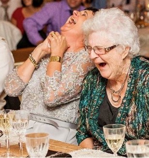 Jenny Hood and her mum Anne Neil laughing it up at a wedding.