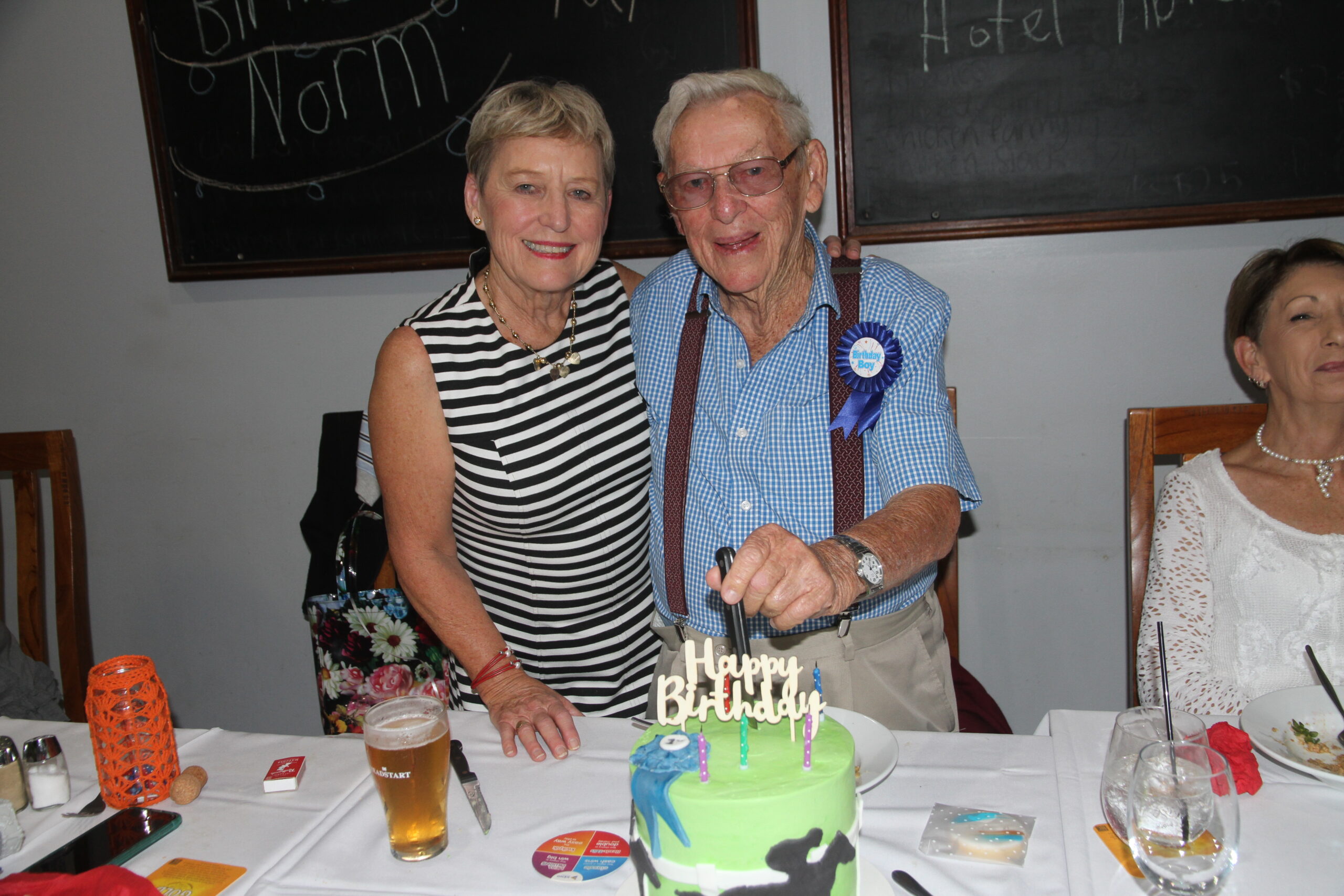 Helen Dugdale and her father Norm Chapman, cutting his 90th birthday cake.