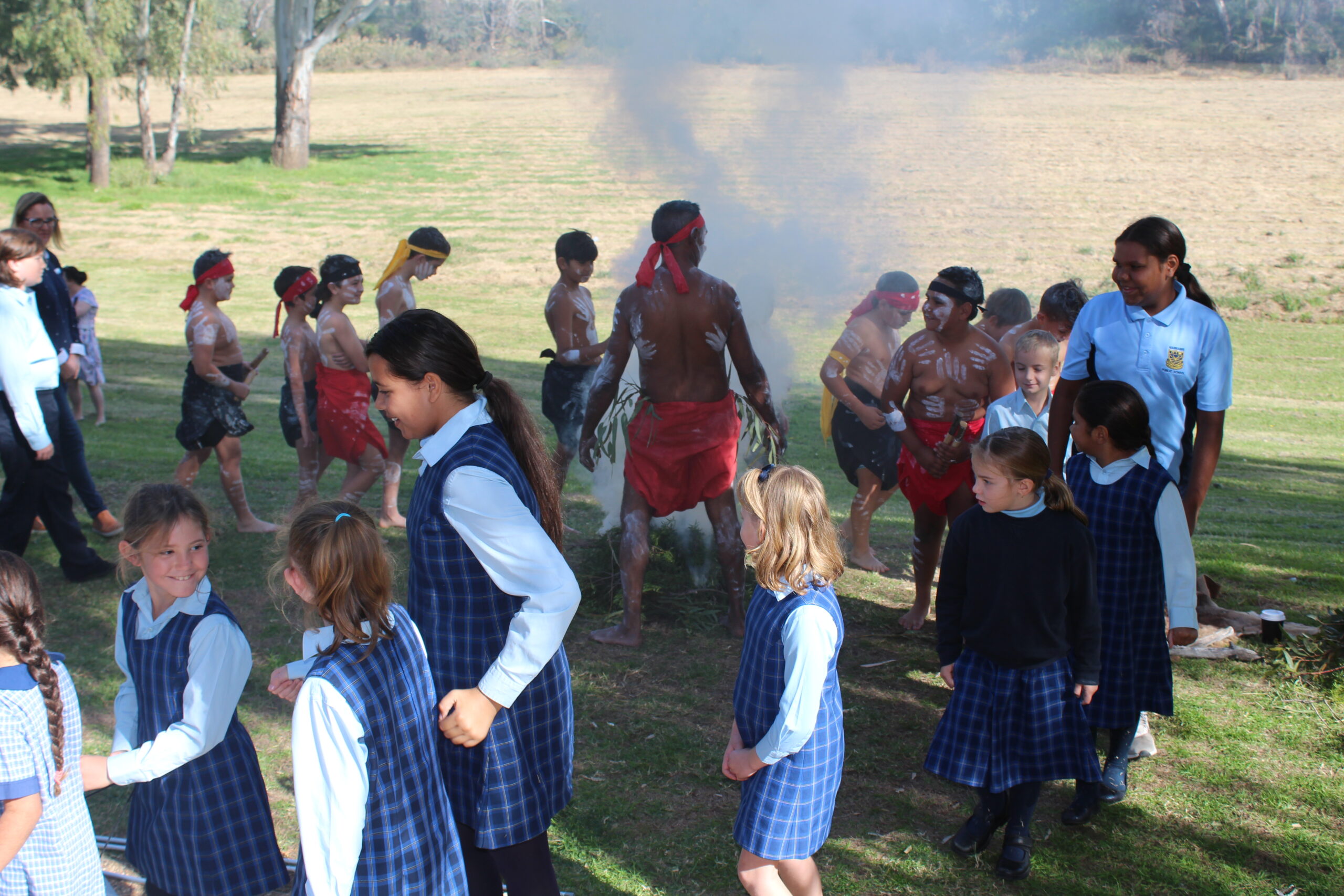 Attendees walking around the fire and through the smoke during the ceremony.