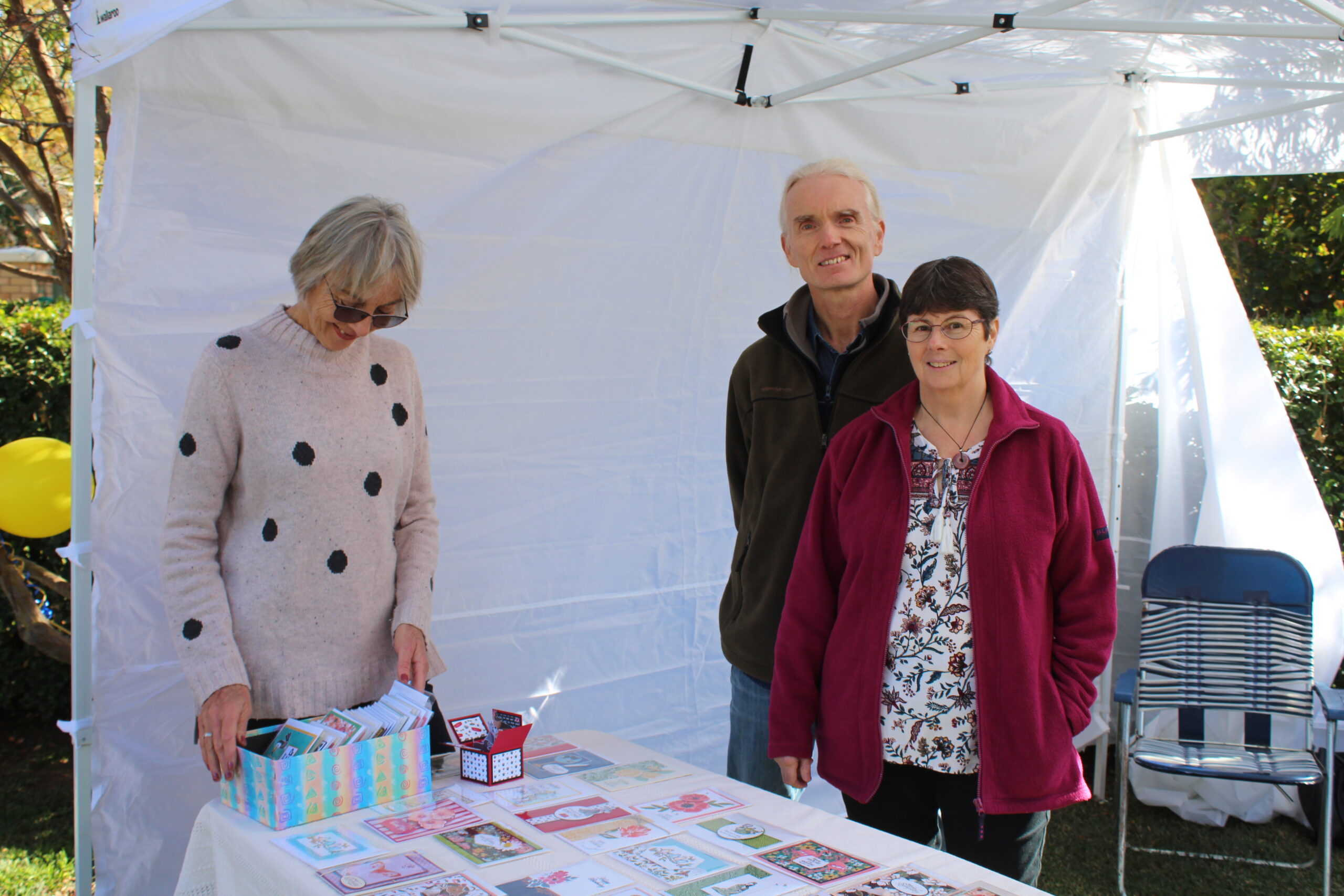 Nanette Watson browsing the handmade goods at Donna’s Paper Craft, with Graeme and Donna Compton.