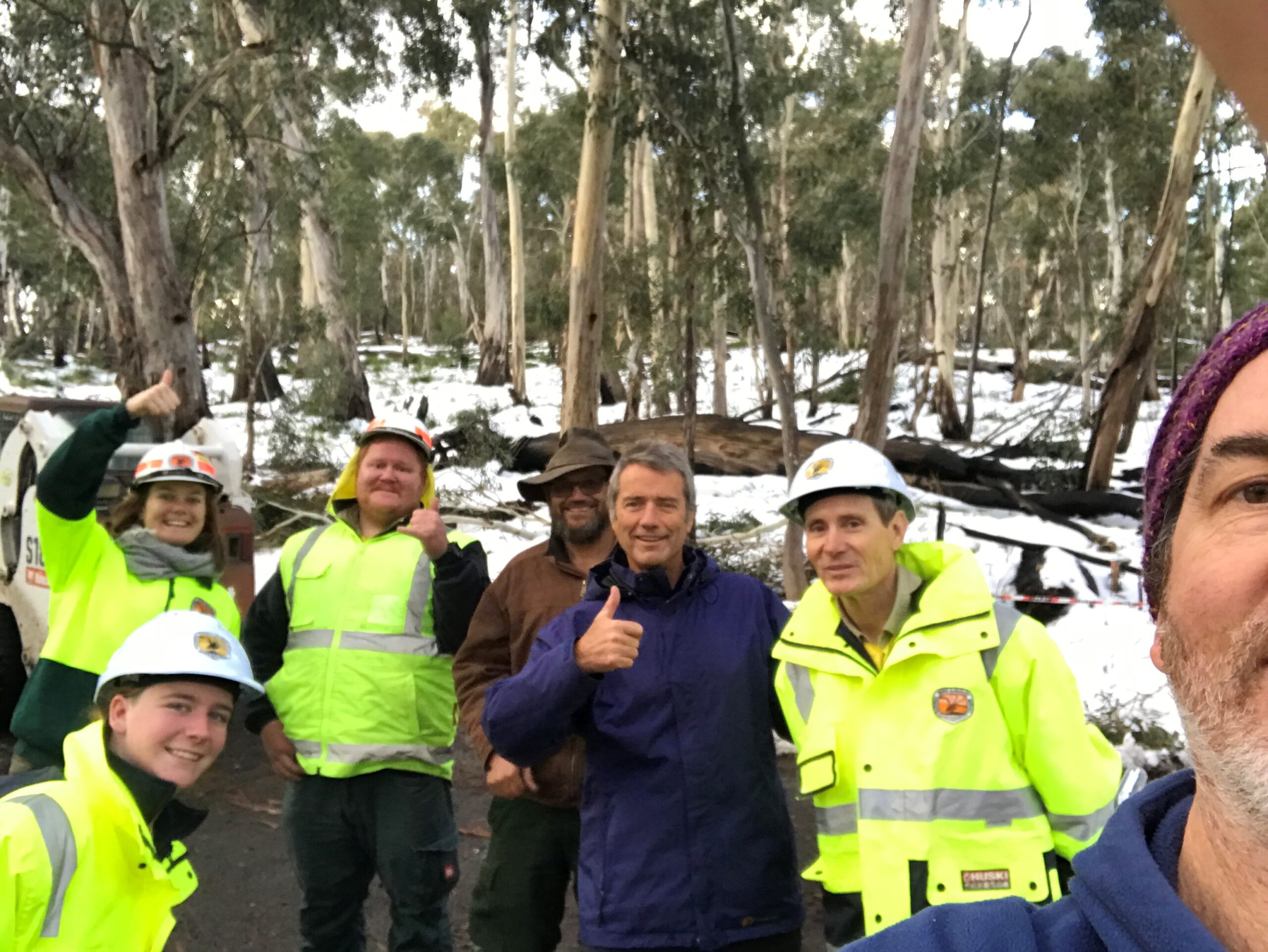 ‘Thanks!’ The evacuees with some of their rescurers, front left, Aimee Fladrick, NPWS, back left, Georgia Hunt, Sam O’Niele, NPWS, Dean Dhu, visitor Dave Gotterson, Peter Berney, NPWS, with visitor Paul Rees behind the camera, right.