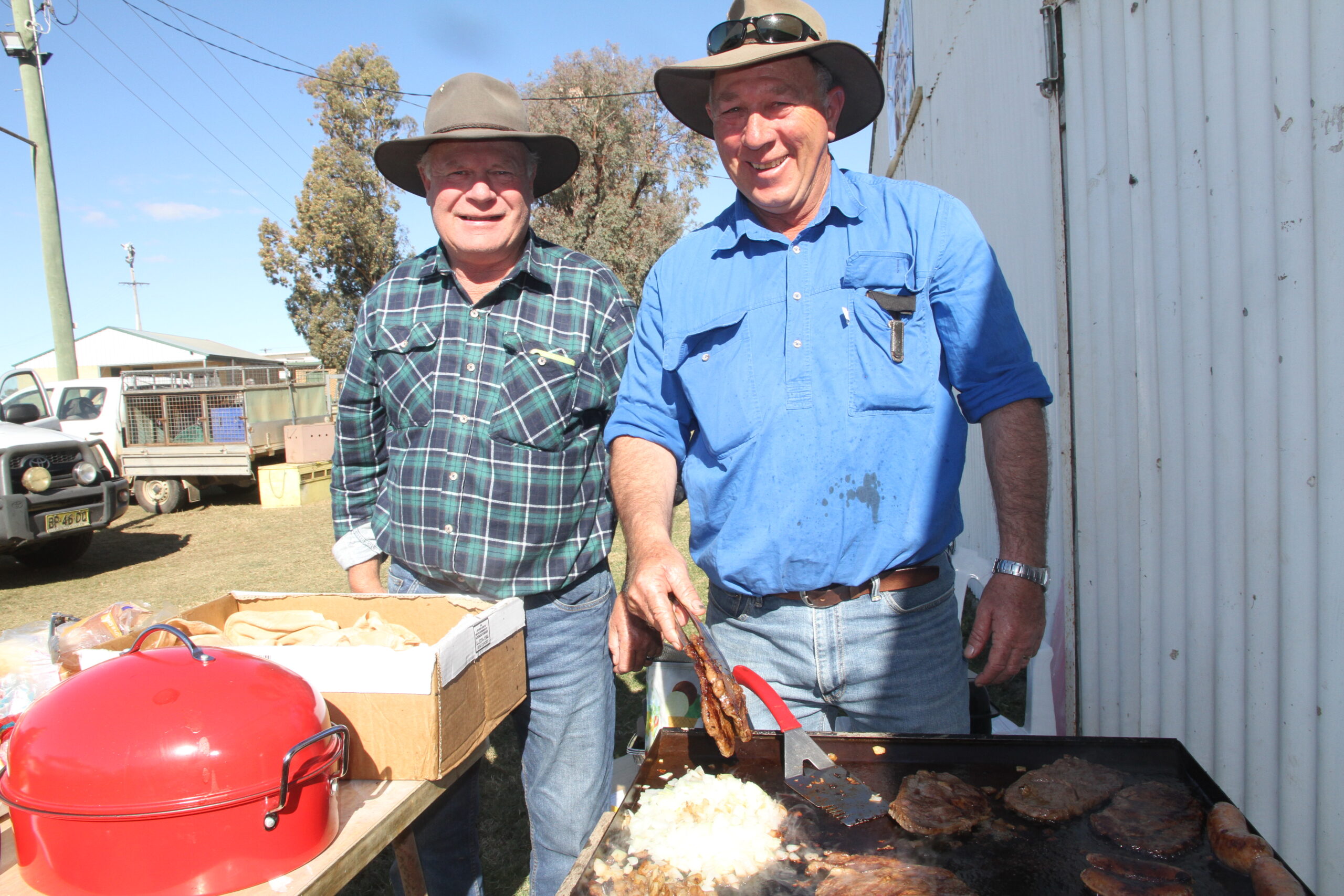 Geoff Hine, Uralla, and Laurence Bruce man the barbecue.