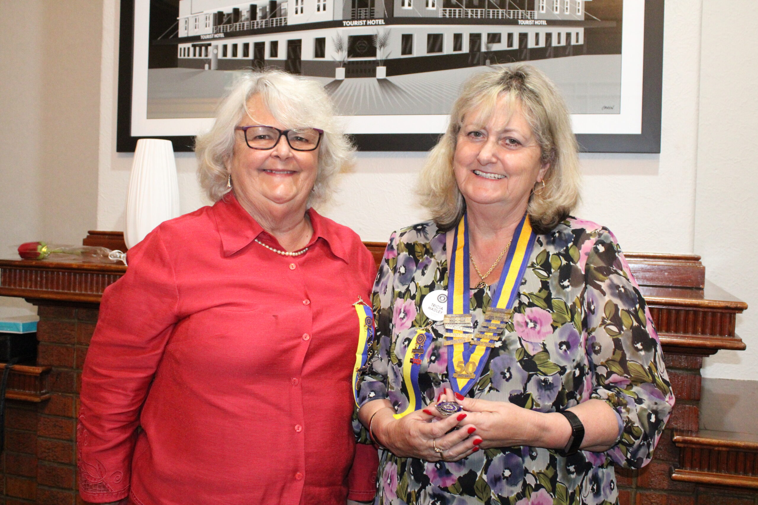 Jenni Hayne congratulates incoming president Tricia Hadley.