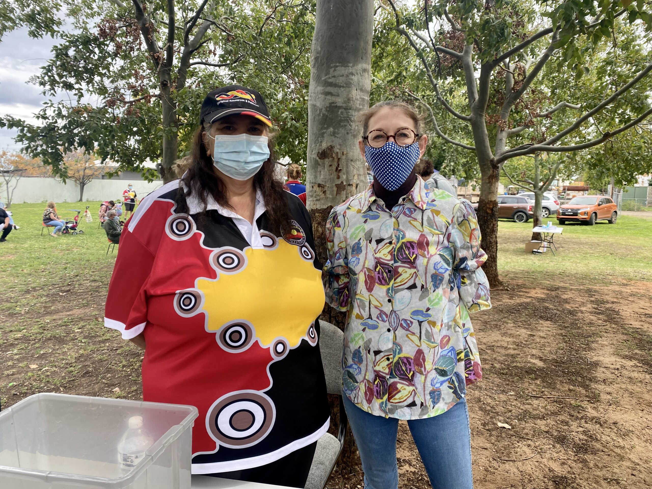 Naomi Nean and Lisa Lisa Almagro distributing COVID-19 vaccination paperwork at the Wee Waa Aboriginal Land Council on Saturday.