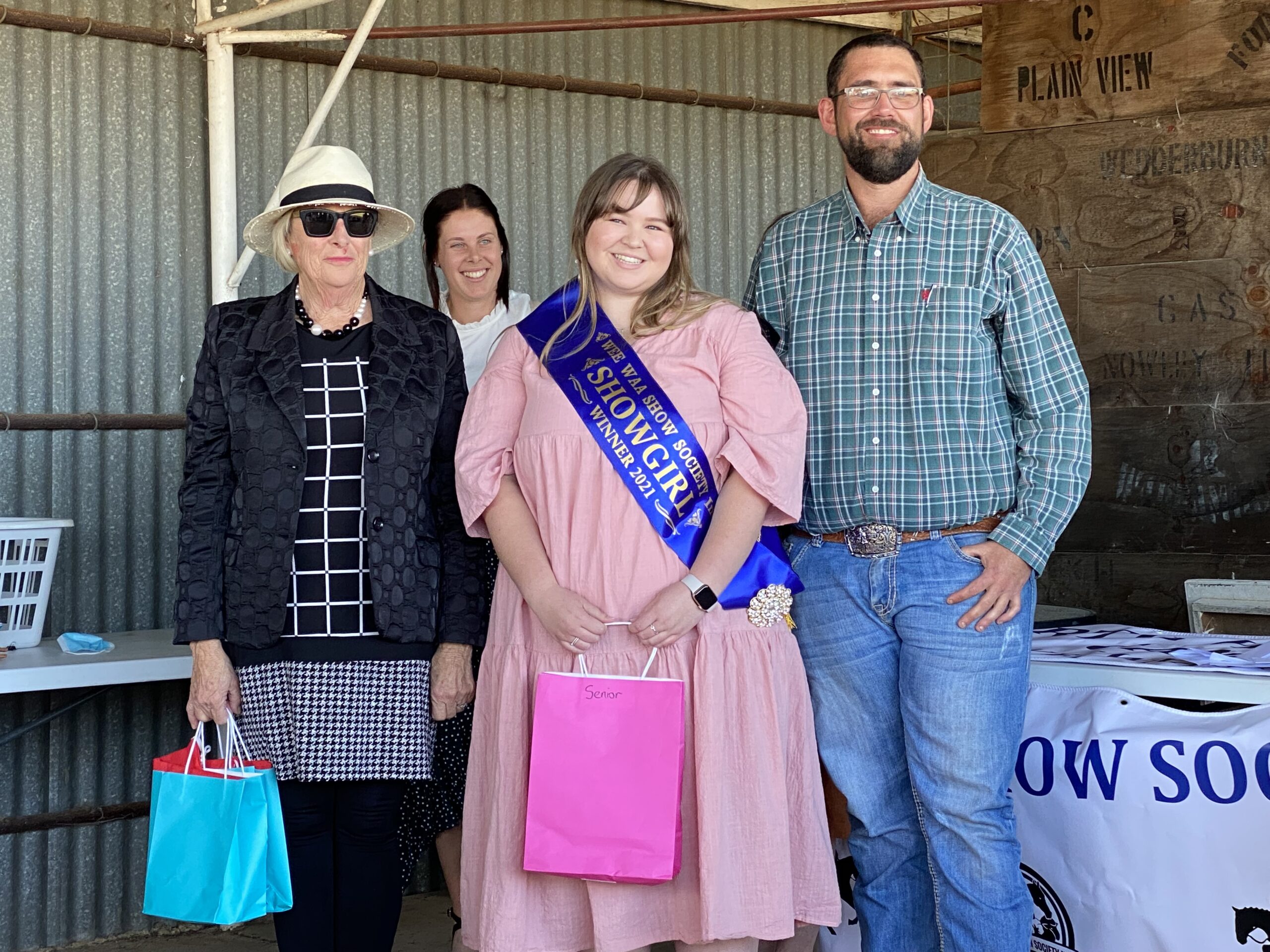 Wee Waa Show society Showgirl coordinator Sue Smith and president Gary Hibbens sashing the 2021 Wee Waa Showgirl Georgia Dickinson.