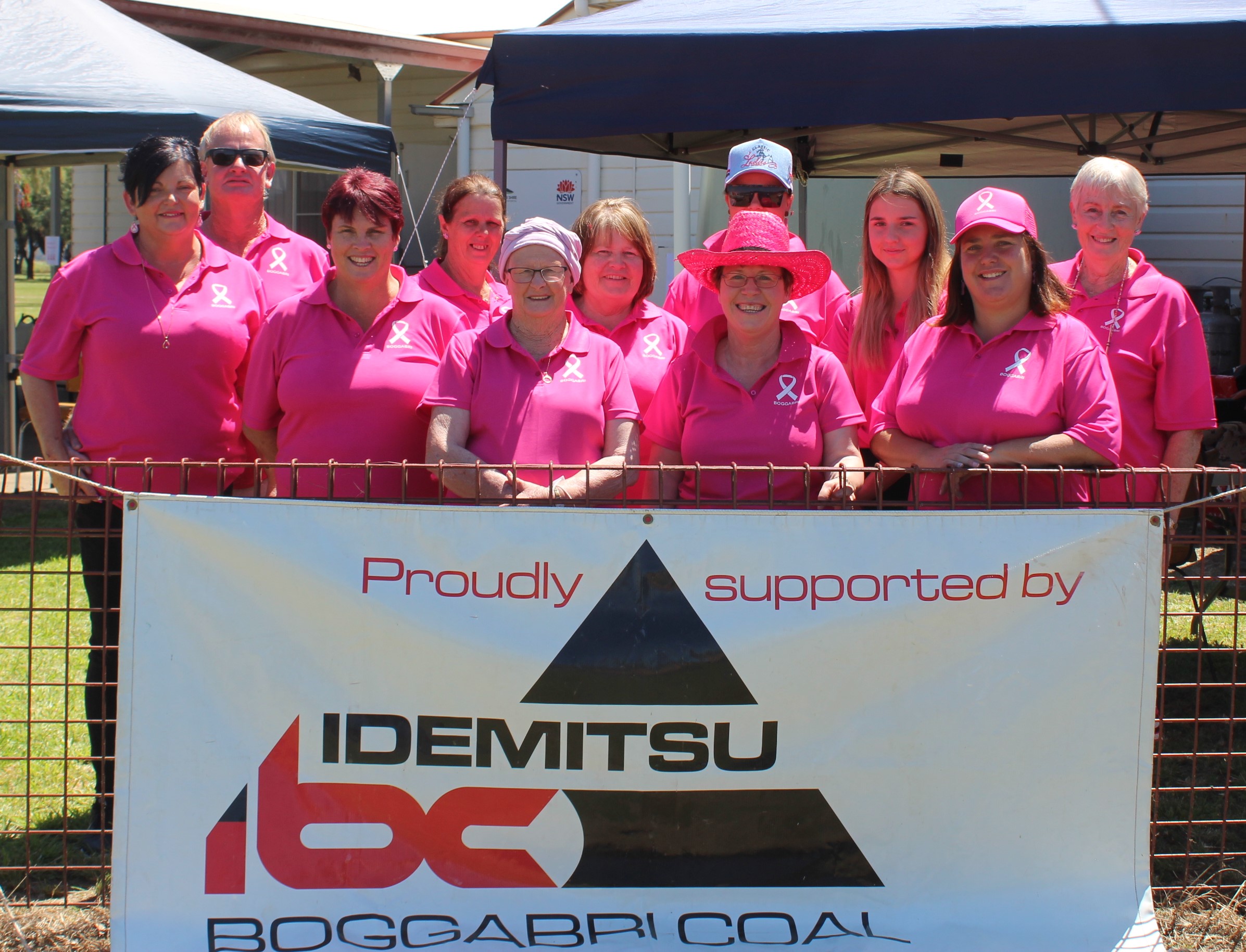 Organising committee: Back, Jeff Hobden, Joanne Tailby, Helen Martin, Paige Cassidy, Maddie House, Noreen Boehm, front, Maria Eggleton, Tracey Cassidy, Margaret Ryan, Robyn Traynor, Paula Neader with the sign after a $5000 donation from Boggabri Coal.
