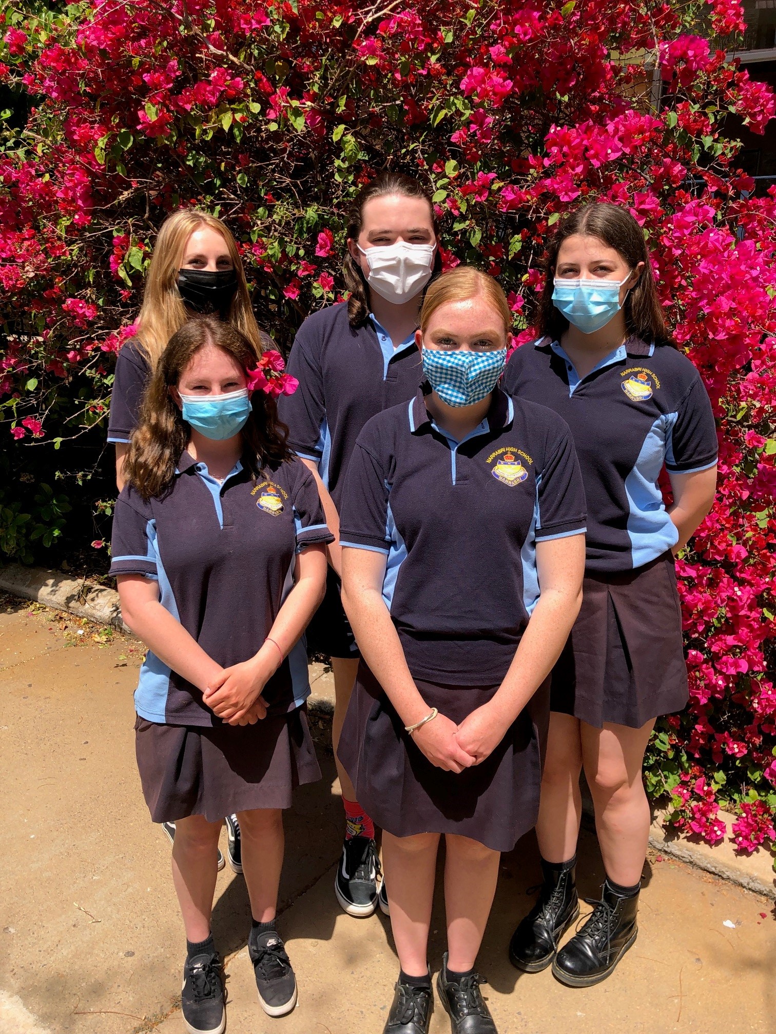 Back, Zara Bennett, Logan Hewett, Addison Russell, front Kaylyn Chater and Poppy Smith making the most of the school’s pretty pink flora.
