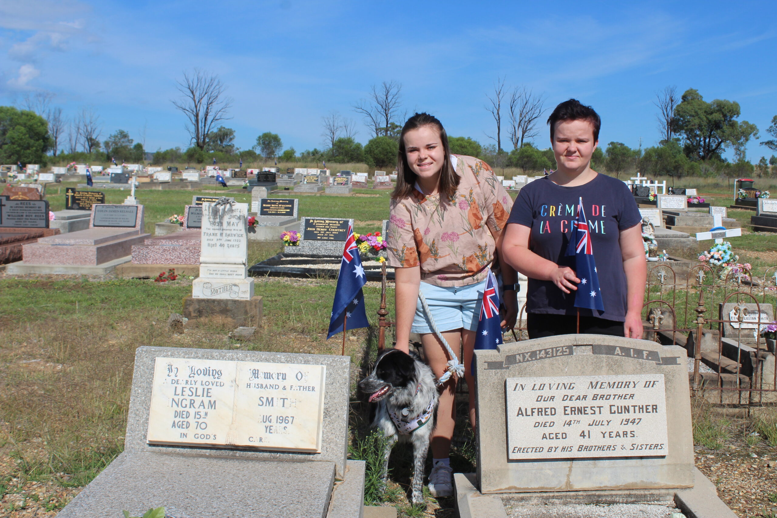 Larissa and Ally Whelan placing flags on Leslie Smith and Alfred Gunther’s graves.
