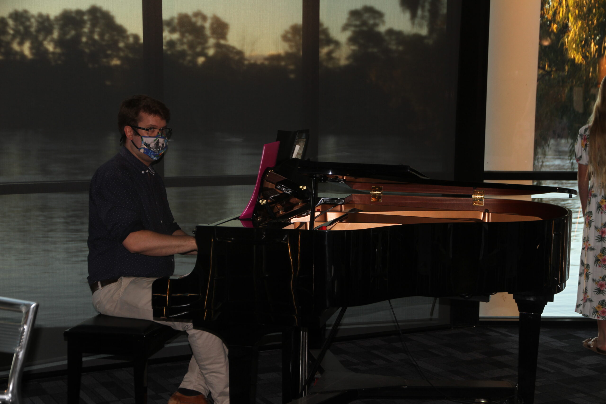 Stephen Bailey performs on the piano at the exhibition opening.