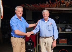 Jamie Condon and his father Ray shake on the business transfer day.