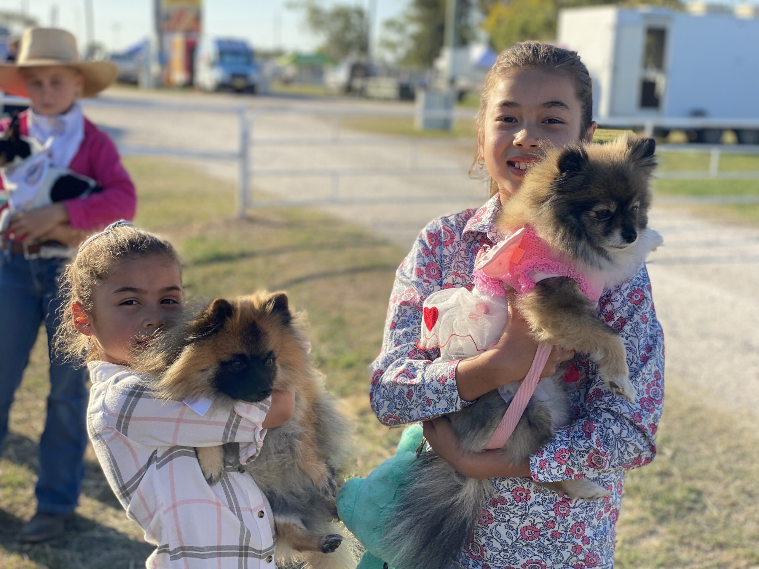 Thea and Jasmine Solomon with their dogs named Pearl and Pommy.