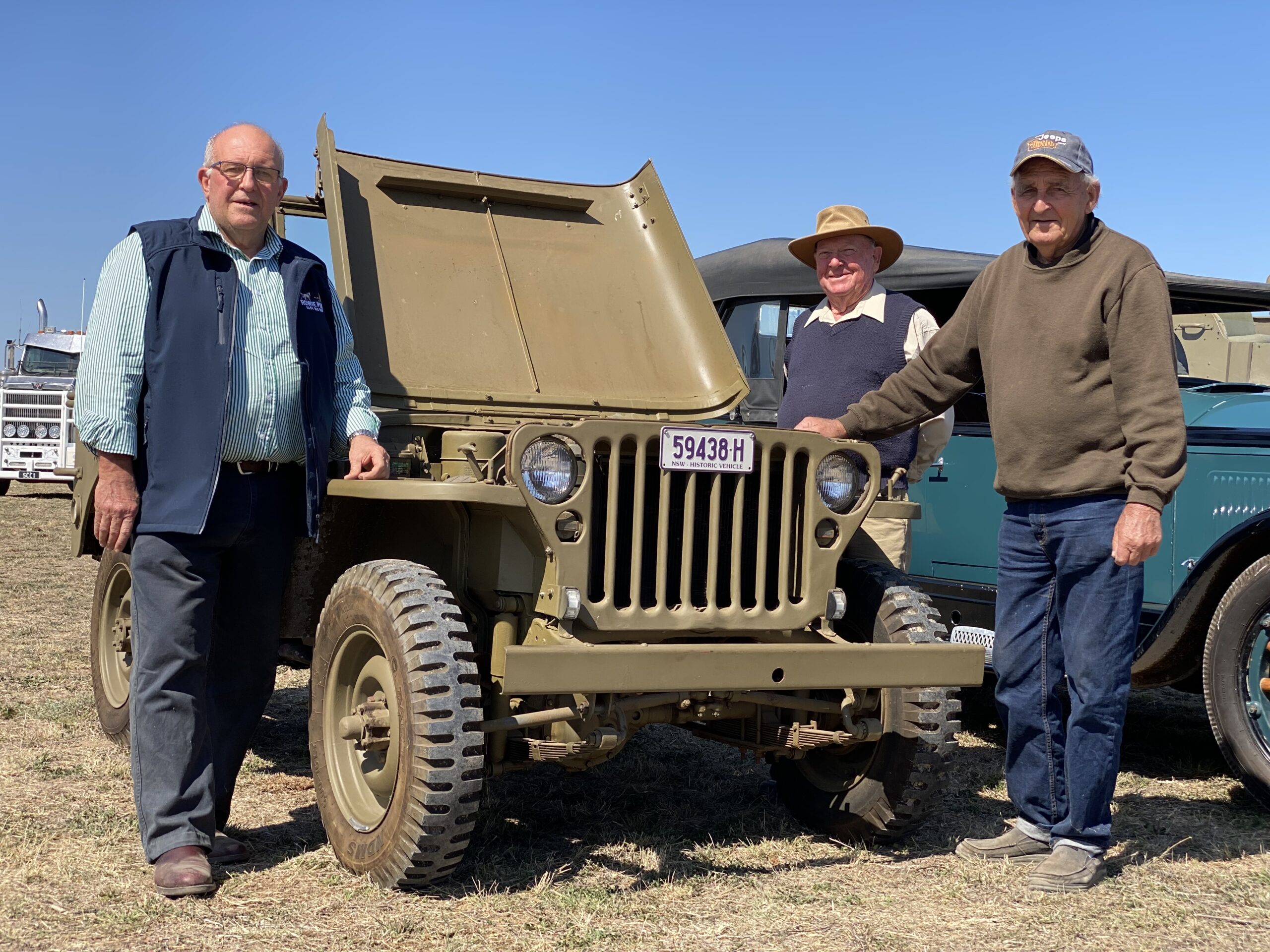 James Woodrow, Warwick Johnson and Ray Johnson standing with a 1943 Willys jeep.