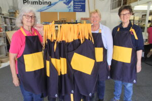 Christine Fry, Jill Clarke and Bron Clarke are pictured with the aprons crafted for Narrabri Public School.