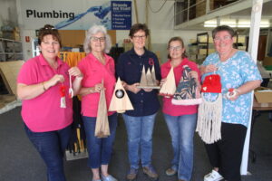 Michelle Wheeler, Christine Fry, Bron Clarke, Kylie Finlay and Janet Pope hold some of the Christmas wares which will be sold at events, including the Narrabri Rotary Markets.