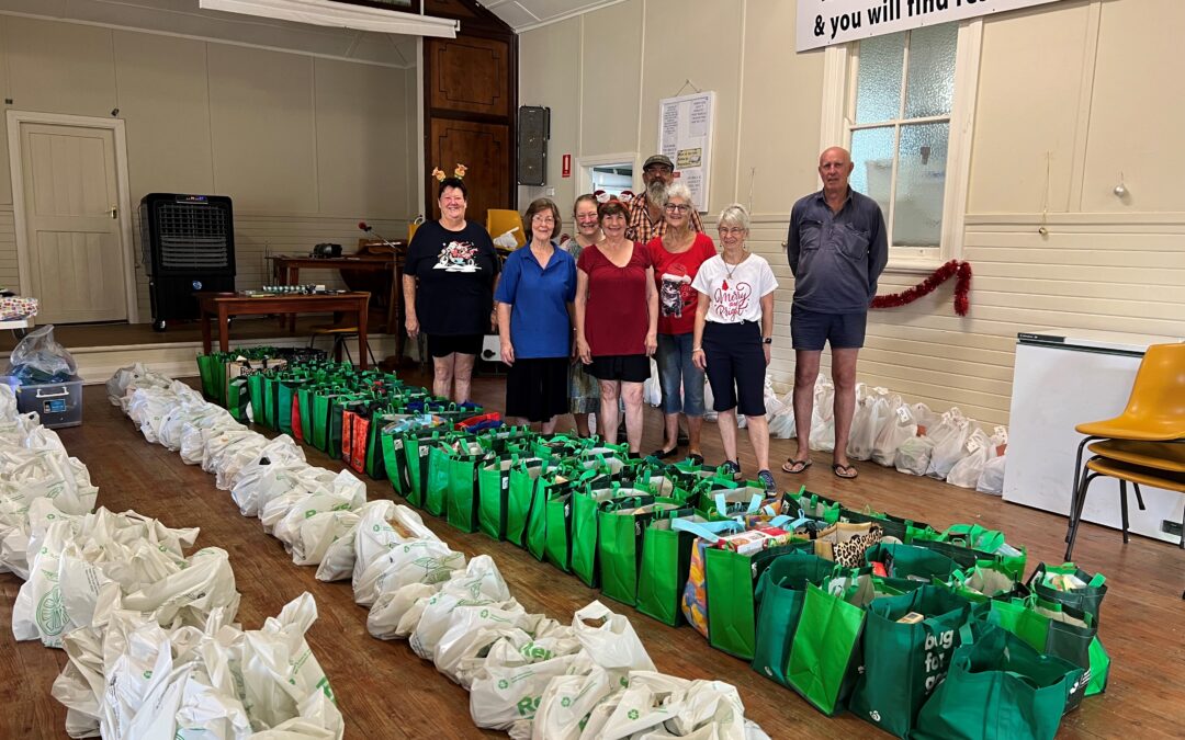 Shared Table overflowing with Christmas hampers and support