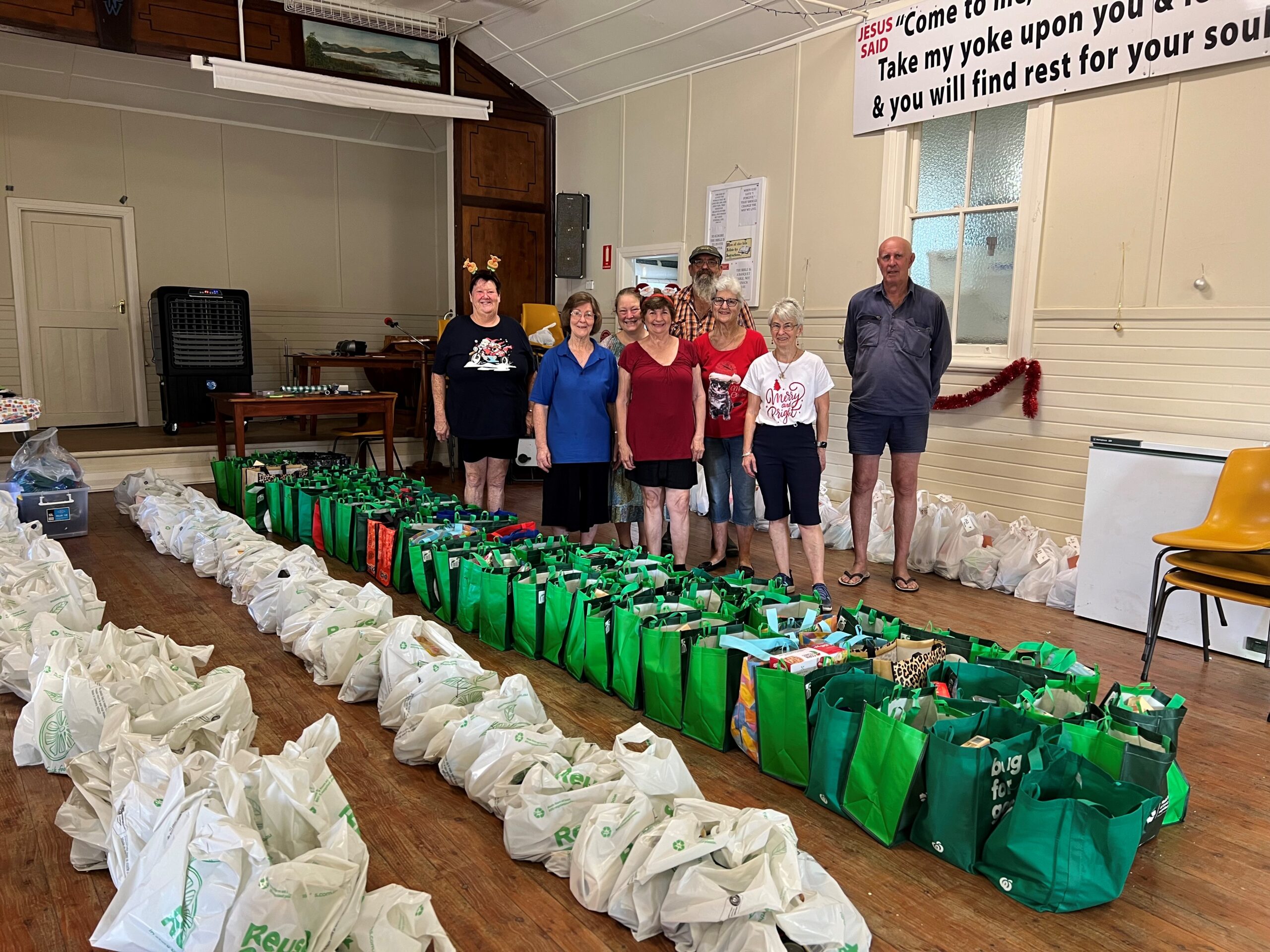 Shared Table overflowing with Christmas hampers and support
