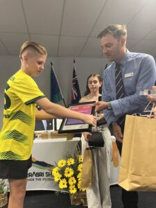 Lennon Simmonds is awarded Junior Sportsman of the Year by mayor Darrell Tiemens.