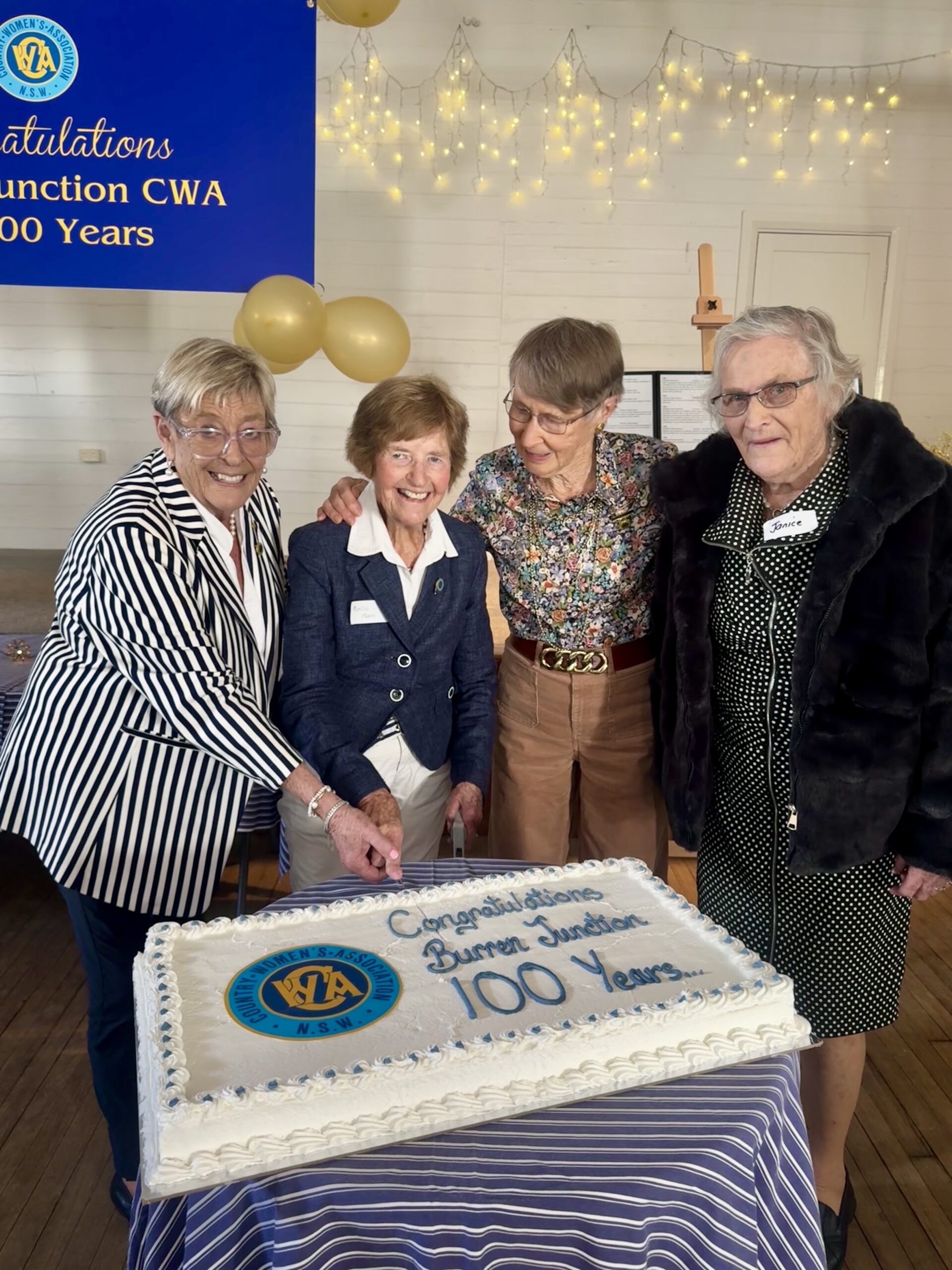 Life members Pam Moore OAM, Marcia Moore, Margaret Sendall and Janice Holcombe cutting the cake at the CWA’s Burren Junction branch 100 years of membership celebration.