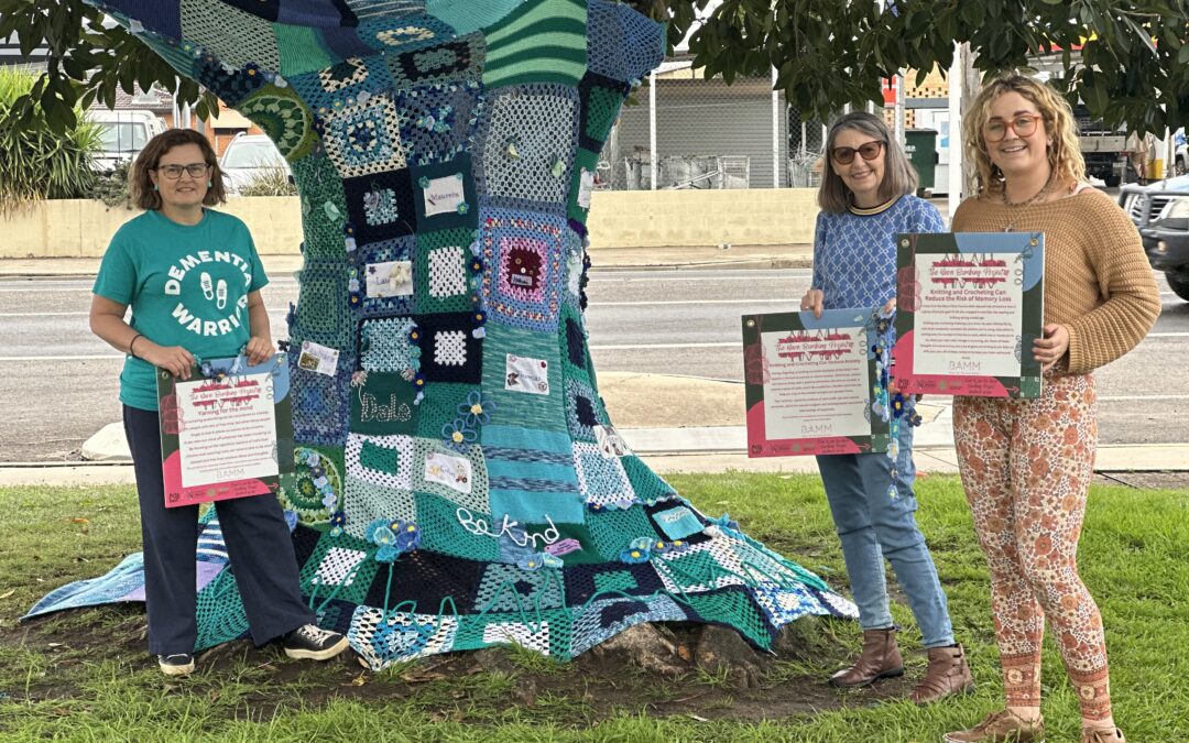 Yarn bombed Dementia Awareness Tree adds splash of colour to highway