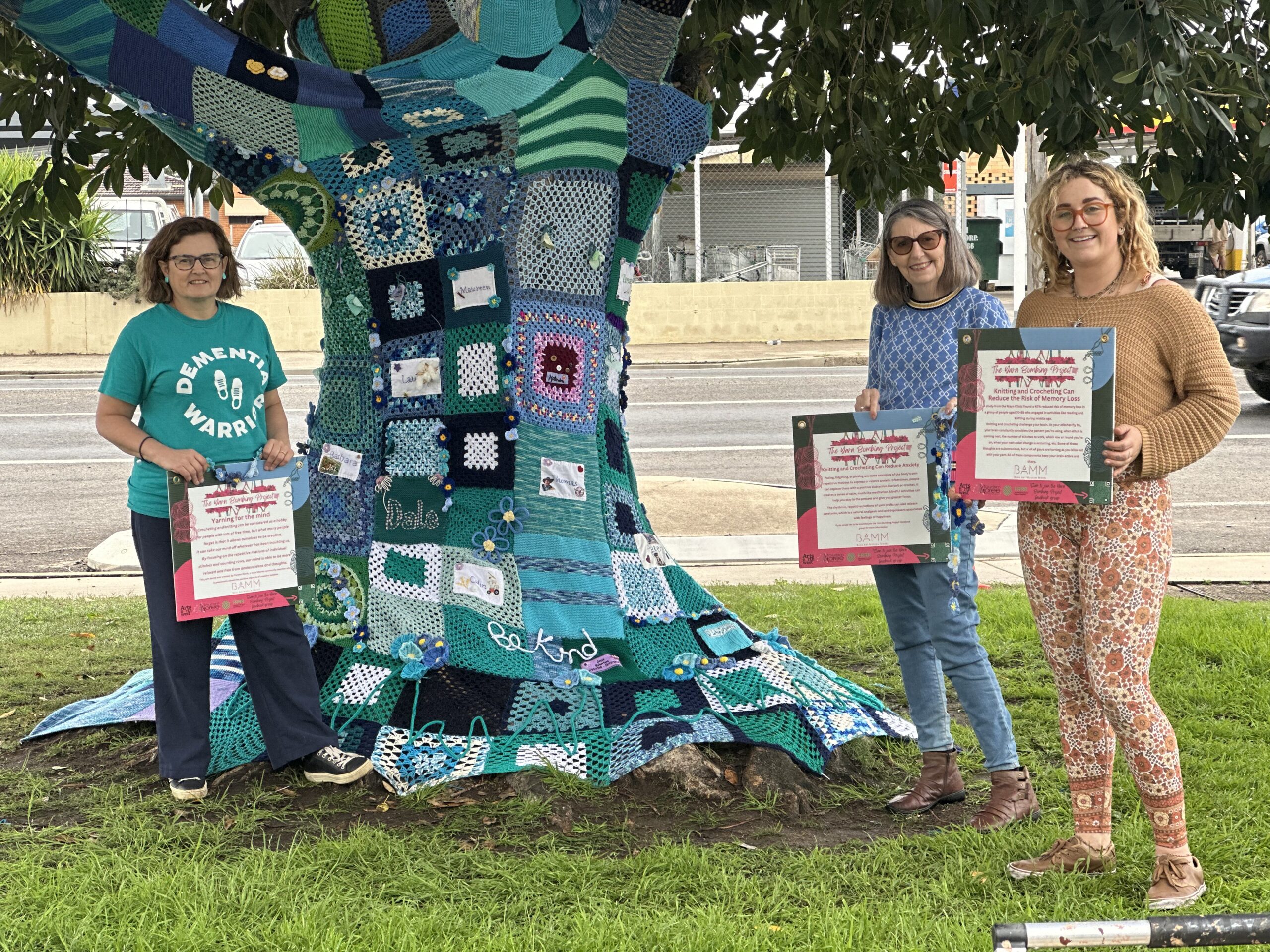 Yarn bombed Dementia Awareness Tree adds splash of colour to highway